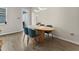 Dining area with a modern table and blue upholstered chairs at 6067 Blue Lily Way, Winter Garden, FL 34787