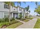 Charming two-story townhome with a landscaped front yard and inviting entrance at 6067 Blue Lily Way, Winter Garden, FL 34787