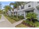 Inviting two-story townhome with lush landscaping and a well-maintained sidewalk at 6067 Blue Lily Way, Winter Garden, FL 34787