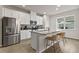 Kitchen featuring a stainless steel refrigerator and a granite island at 6067 Blue Lily Way, Winter Garden, FL 34787