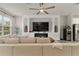 Stylish living room featuring a large sofa, modern fireplace, and a wine cooler at 6067 Blue Lily Way, Winter Garden, FL 34787