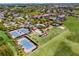Aerial view featuring community tennis courts, pool, and clubhouse set within a well-maintained community at 637 Conservation Blvd, Groveland, FL 34736