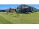 Lush lawn with a screened-in patio perfect for outdoor entertaining at 637 Conservation Blvd, Groveland, FL 34736