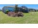 Manicured backyard featuring a screened-in patio and tasteful landscaping at 637 Conservation Blvd, Groveland, FL 34736