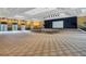 Spacious ballroom with stage, recessed lighting, neutral carpet, and ample seating at 637 Conservation Blvd, Groveland, FL 34736