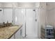 Bathroom featuring glass enclosed shower with tile, granite countertop and modern fixtures at 637 Conservation Blvd, Groveland, FL 34736