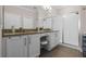 Elegant bathroom featuring double sinks, granite countertops, and a spacious glass-enclosed shower at 637 Conservation Blvd, Groveland, FL 34736