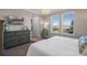 This well-lit bedroom offers ample natural light and features modern decor at 637 Conservation Blvd, Groveland, FL 34736