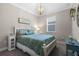 Cozy bedroom with a decorative chandelier and large window for ample natural light at 637 Conservation Blvd, Groveland, FL 34736