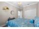 Comfortable bedroom featuring a chandelier, and decor at 637 Conservation Blvd, Groveland, FL 34736