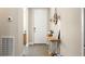 Entryway showcasing a console table with coastal decor and wood-look tile flooring at 637 Conservation Blvd, Groveland, FL 34736
