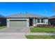 Charming single-story home with a two-car garage and landscaped front yard at 637 Conservation Blvd, Groveland, FL 34736