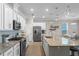 Spacious kitchen with stainless appliances, granite counters, and pendant lighting at 637 Conservation Blvd, Groveland, FL 34736