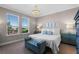 Bright main bedroom with large windows, chandelier, blue accents, and carpeted flooring at 637 Conservation Blvd, Groveland, FL 34736