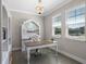 Stylish office space with a chandelier, built-in bookcase, and ample natural light at 637 Conservation Blvd, Groveland, FL 34736