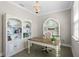 Bright home office with custom bookshelves, desk and chair, and a chandelier at 637 Conservation Blvd, Groveland, FL 34736