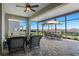 Covered patio with wicker seating, and outdoor dining area at 637 Conservation Blvd, Groveland, FL 34736