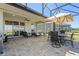 Relaxing screened-in patio with comfortable seating and stylish brick pavers at 637 Conservation Blvd, Groveland, FL 34736