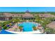 Community pool surrounded by lounge chairs, palm trees, and community buildings at 637 Conservation Blvd, Groveland, FL 34736