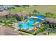 Aerial view of the community pool and pool-house featuring ample seating and blue shade coverings at 637 Conservation Blvd, Groveland, FL 34736