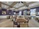 Social room in community center with comfortable seating and tables for games and conversation at 637 Conservation Blvd, Groveland, FL 34736