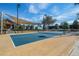 Outdoor tennis court featuring lighting and sun shade sail, adding to the property's recreational options at 637 Conservation Blvd, Groveland, FL 34736