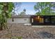 Exterior view of the home's backyard with a screened in porch and mature trees at 703 Sailfish Rd, Winter Springs, FL 32708
