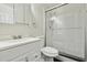 Modern bathroom with a glass-enclosed shower, vanity, and classic black and white tile accents at 703 Sailfish Rd, Winter Springs, FL 32708
