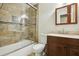 Bathroom with glass door shower, bathtub, and tile surround at 703 Sailfish Rd, Winter Springs, FL 32708