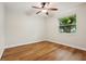 Bedroom featuring a ceiling fan, wood floors, and a large window at 703 Sailfish Rd, Winter Springs, FL 32708