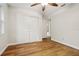 Bedroom with wood floors, ceiling fan, and en-suite bathroom at 703 Sailfish Rd, Winter Springs, FL 32708