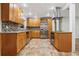 Kitchen with tile flooring, stainless steel appliances, and wooden cabinets at 703 Sailfish Rd, Winter Springs, FL 32708