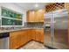 Kitchen with stainless steel appliances, granite countertops, and a large window at 703 Sailfish Rd, Winter Springs, FL 32708