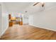 A living room with wood flooring, light-colored walls and a view into the kitchen at 703 Sailfish Rd, Winter Springs, FL 32708