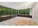 Relaxing screened porch area with tile floors, offering views of the lush greenery at 703 Sailfish Rd, Winter Springs, FL 32708