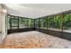 Spacious screened porch with tile flooring, perfect for enjoying the outdoors at 703 Sailfish Rd, Winter Springs, FL 32708