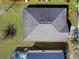 Overhead view highlighting roof, landscaping, adjacent properties, and backyard at 734 Andalusia Loop, Davenport, FL 33837