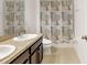 Bathroom featuring double sinks, granite countertops and a tiled shower tub combination at 734 Andalusia Loop, Davenport, FL 33837