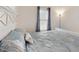 Cozy bedroom featuring a white headboard, nautical themed bedding and a window with natural light at 734 Andalusia Loop, Davenport, FL 33837