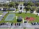 Aerial of a well-maintained community park with tennis court, playground, and ample parking at 734 Andalusia Loop, Davenport, FL 33837