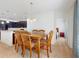 Cozy dining area with a wooden table, matching chairs, and view of the kitchen and bedroom at 734 Andalusia Loop, Davenport, FL 33837