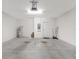 Uncluttered two-car garage featuring water heater, electrical panel and access door at 734 Andalusia Loop, Davenport, FL 33837
