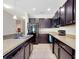 Spacious kitchen featuring stainless steel appliances, dark wood cabinets, and tile flooring at 734 Andalusia Loop, Davenport, FL 33837