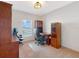 Home office space with wood desk, bookshelves, and a rolling office chair at 734 Andalusia Loop, Davenport, FL 33837
