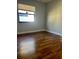 This bedroom features wood-look floors, natural light and space at 7520 Marietta St, Orlando, FL 32807