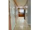 Hallway leading to the kitchen, featuring tiled floors and a built in cabinet at 7520 Marietta St, Orlando, FL 32807
