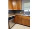 Cozy kitchen featuring wooden cabinets, stainless steel appliances, and natural light from the window at 7520 Marietta St, Orlando, FL 32807