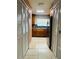 Galley kitchen featuring wooden cabinets, stainless steel appliances, and tiled flooring at 7520 Marietta St, Orlando, FL 32807