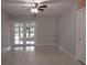 Bright living room with tiled floor, gray walls and a door leading to the outside at 7520 Marietta St, Orlando, FL 32807