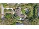 Bird's-eye view of a private estate featuring a lush backyard, a sparkling pool, mature trees and a sprawling layout at 8244 Oakland Pl, Orlando, FL 32819